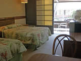 Image of a double bed on the Waikiki Beach resort rooms & rates page.